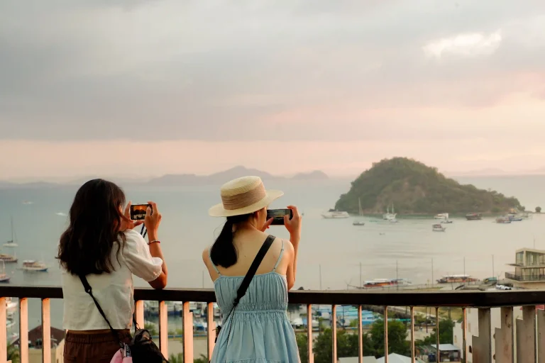 Travellers looking out over island bays in eastern Indonesia